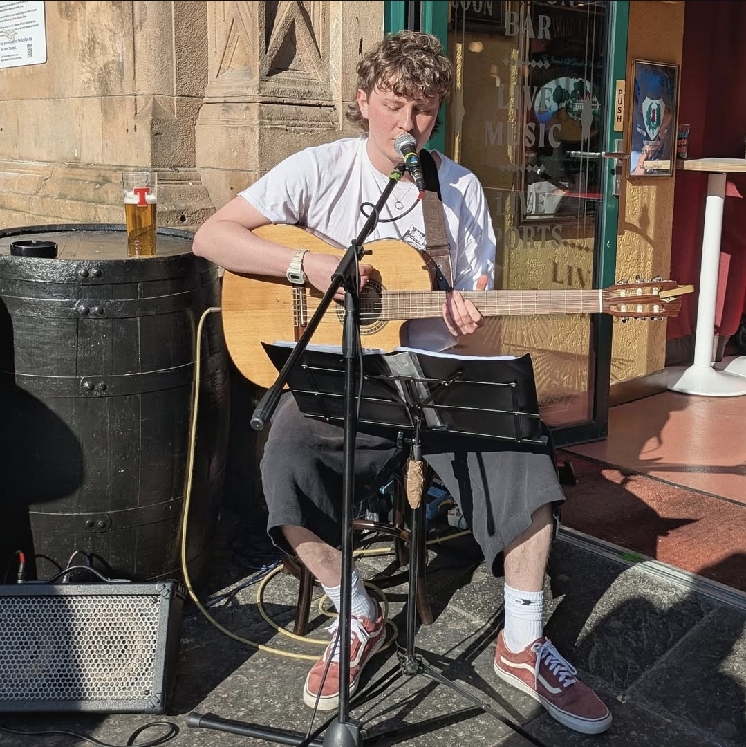 Ross playing live music at a pub gig in Glasgow
